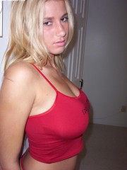 Young teen blonde looks hot showing off her big juicy jugs and playing with dildo