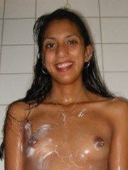 Nude shaved pussy indian babe taking a shower before posing in the bed.