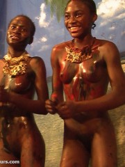 Two nasty ebony chicks in leopard g strings and with a blindfold getting their bodies covered with paints when having fun